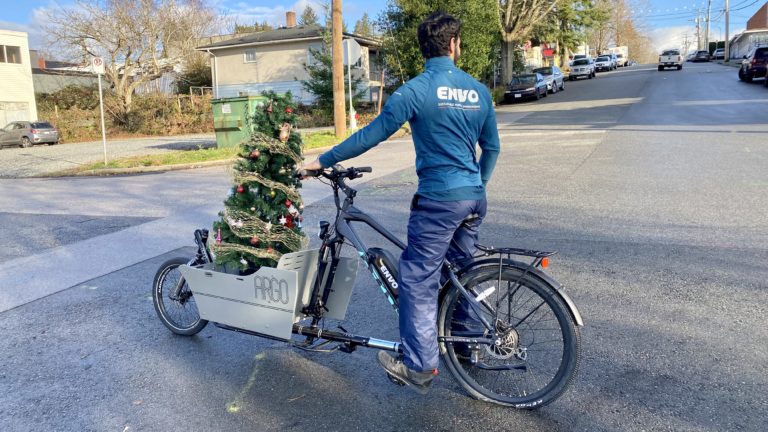 Man riding Envo cargo bike with Christmas tree